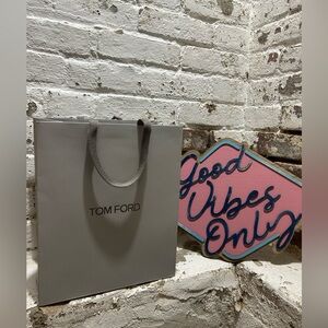 Tom Ford bag, tissue paper and ribbon in gray and black. 
So chic!
